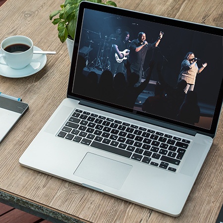 laptop with worship team video