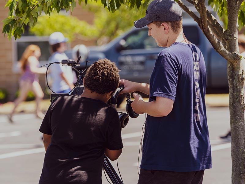 Young men working with a video camera