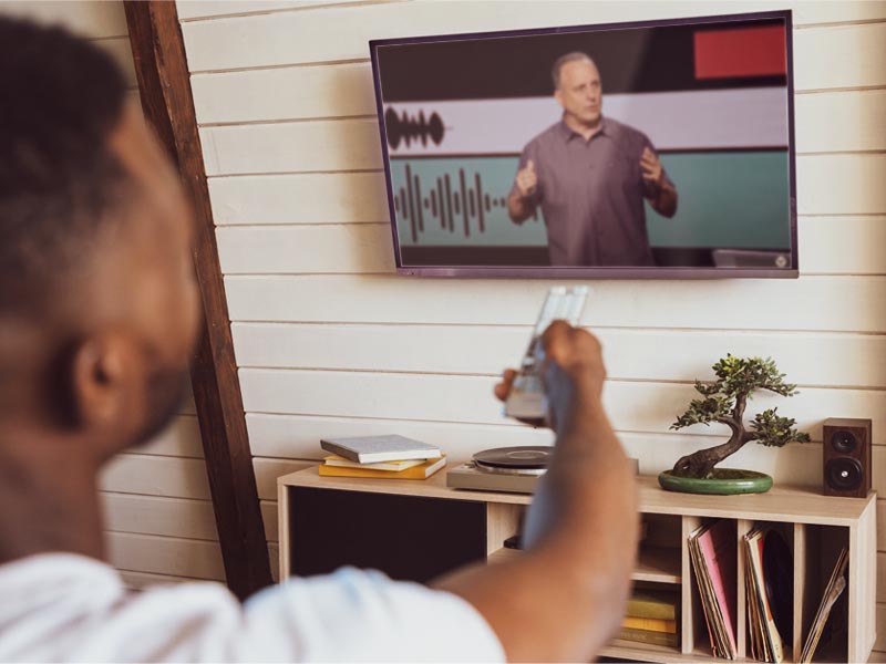 Person watching a Victory Family Church service on TV