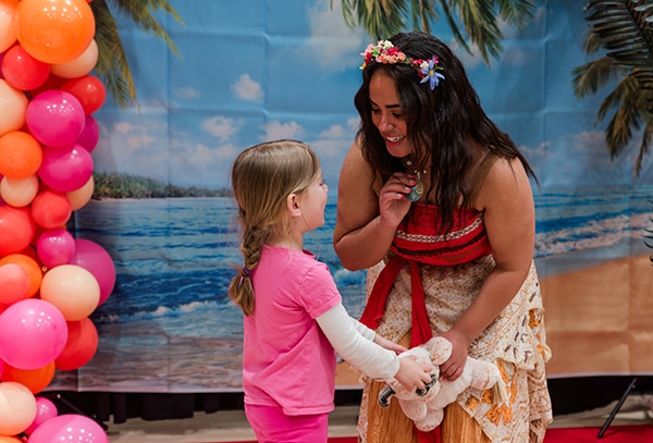 Young girl with costumed character 