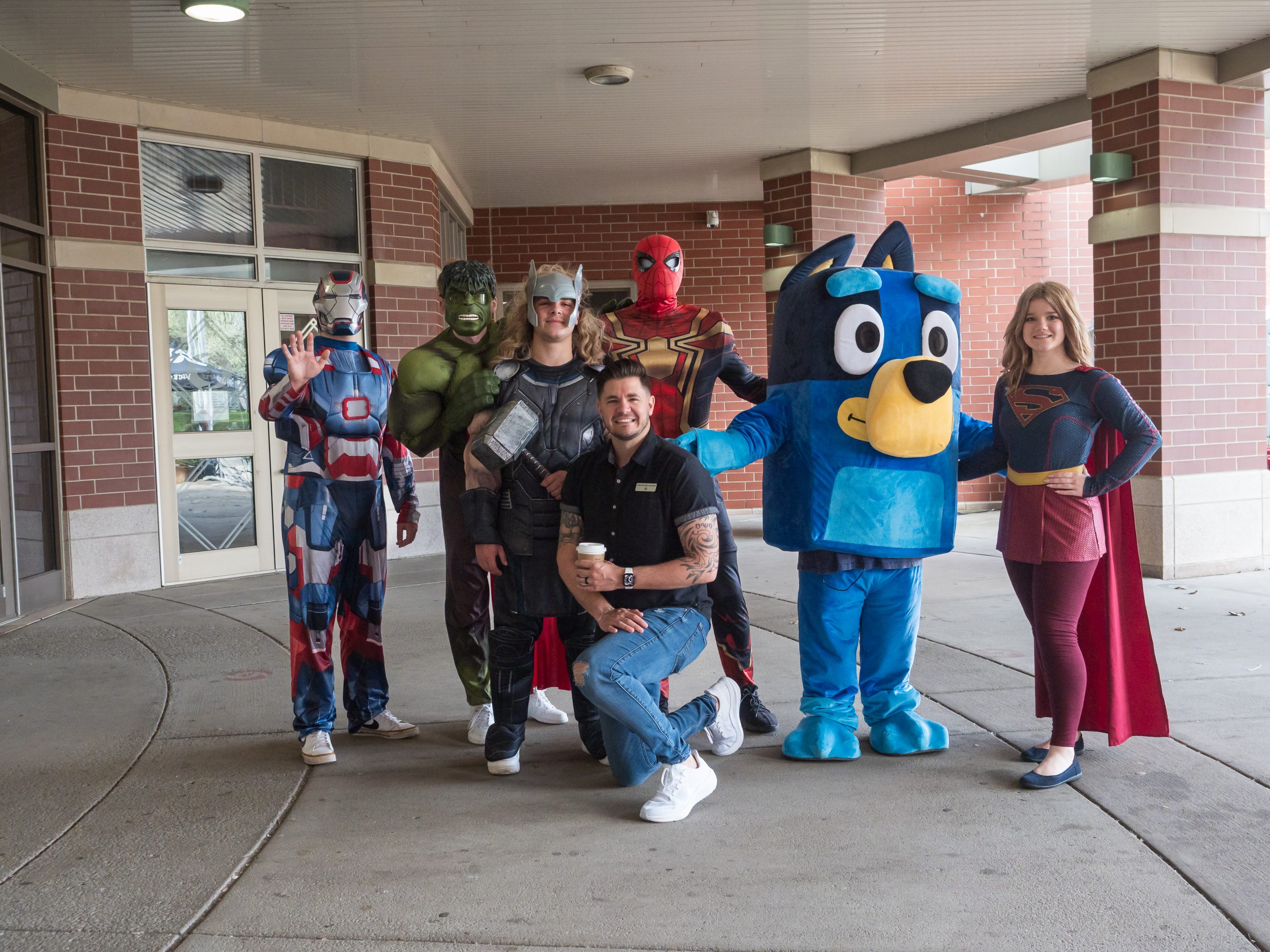 OLYMPUS DIGITAL CAMERA Two small girls sitting next to a volunteer in an Easter Bunny costume